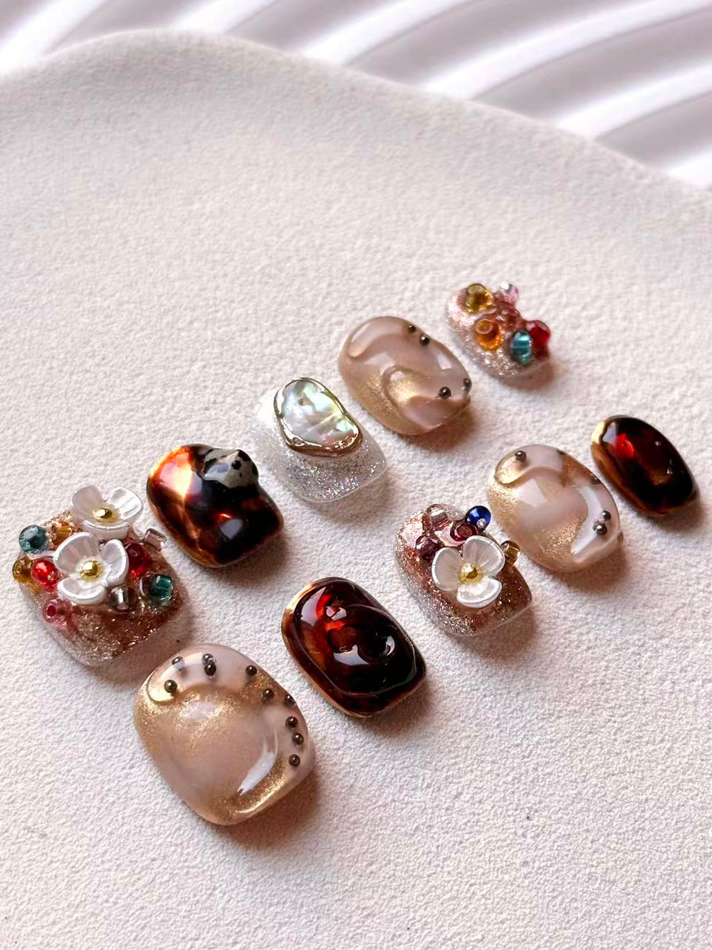 Full 10-piece set of luxury press-on nails featuring  3D white floral designs