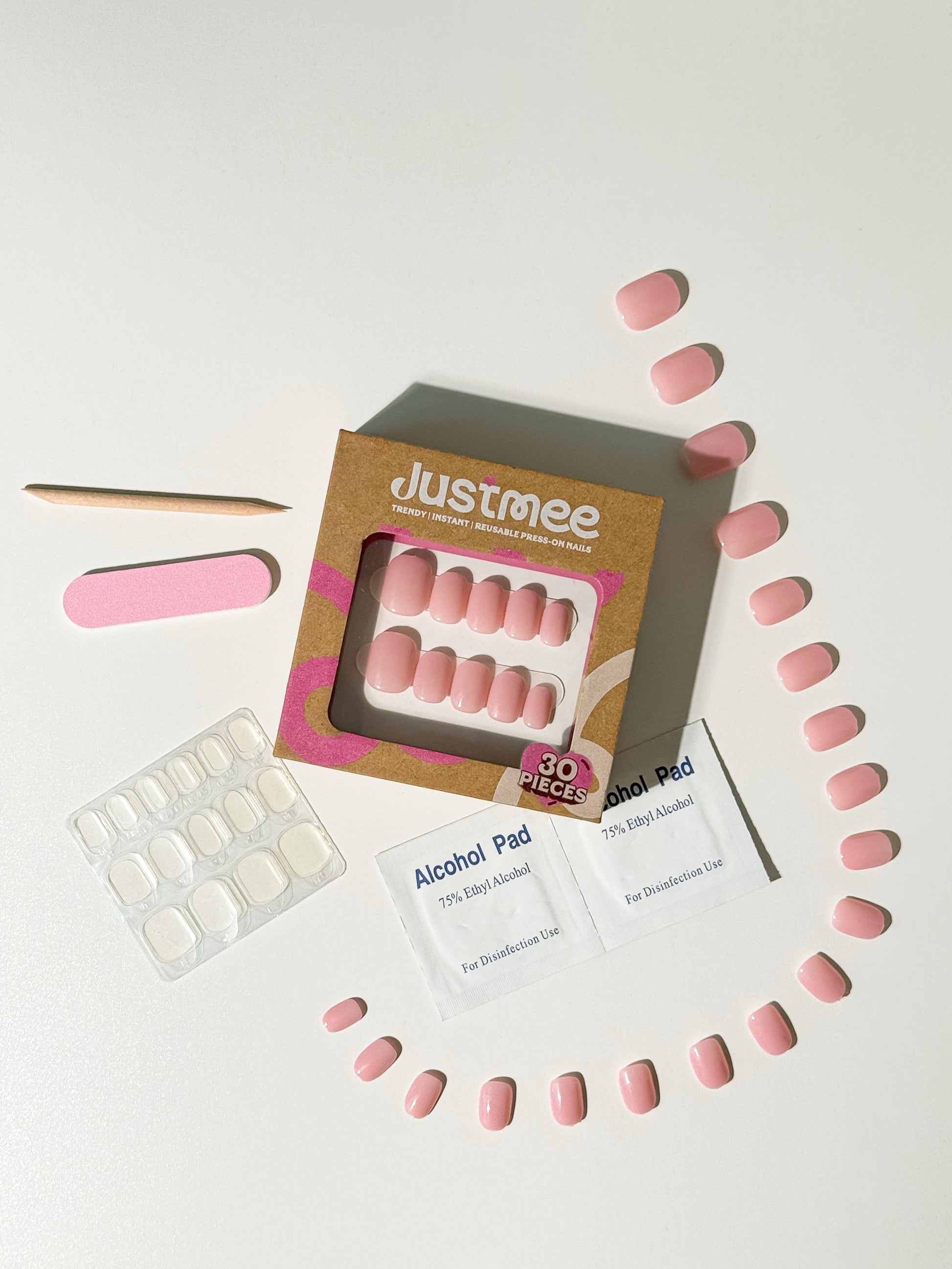 Justmee 30-piece press-on nail kit featuring sheer aurora pink jelly nails and application tools.