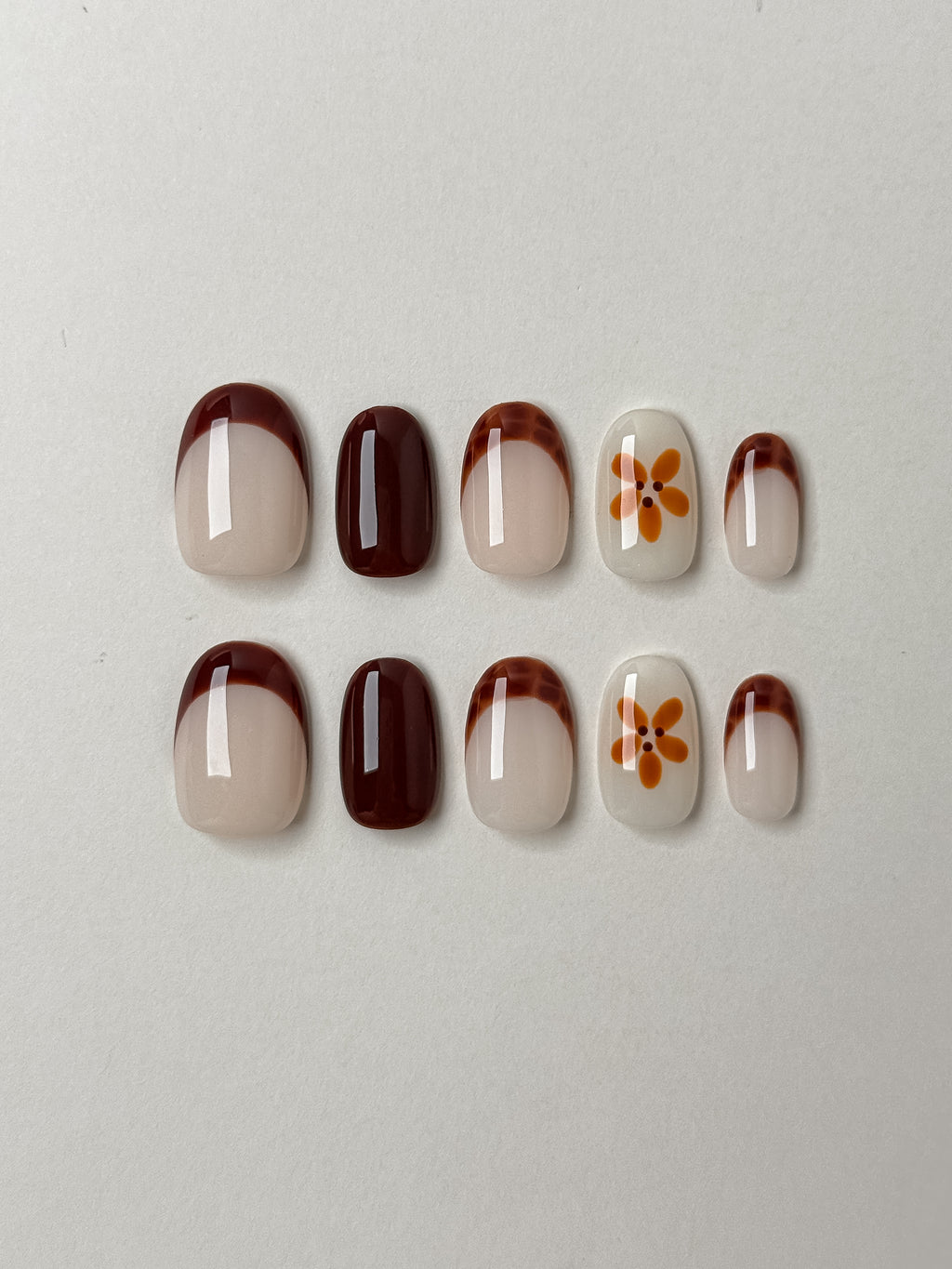 10-piece short round oval press-on nail set featuring tortoise shell tips and amber floral art