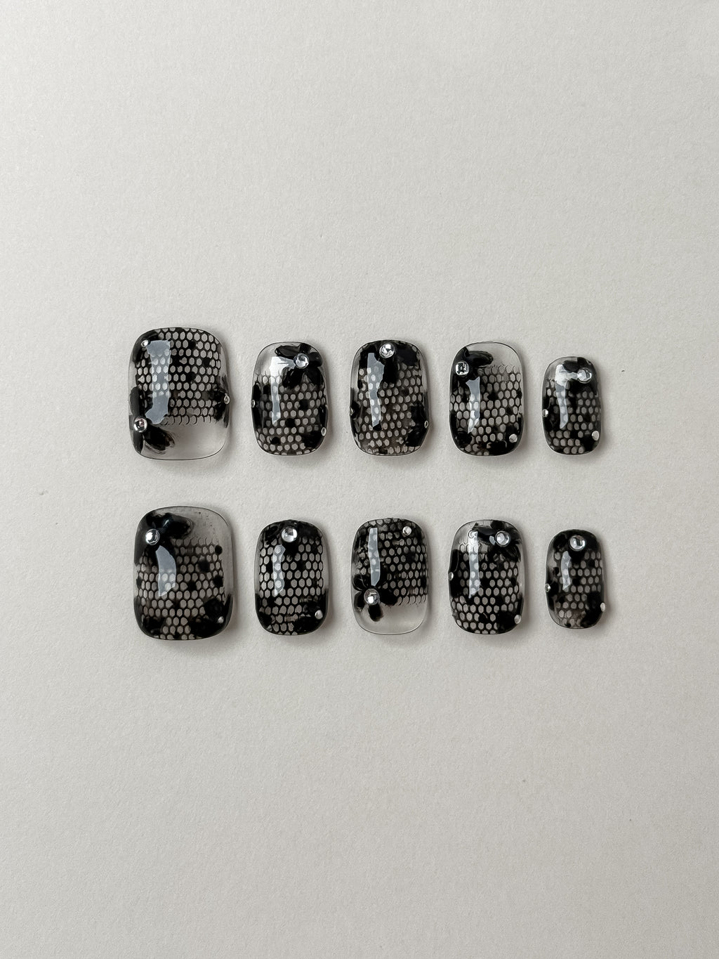 10-piece short square transparent press on nail set featuring black lace art