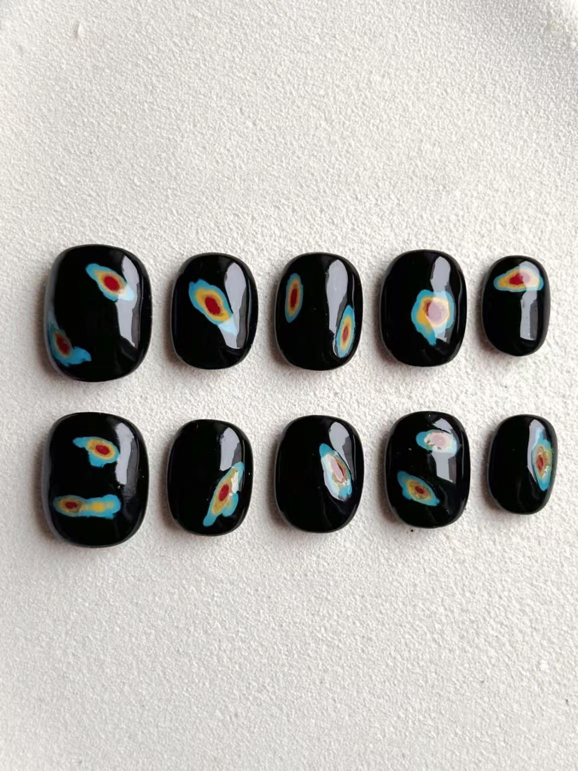 Shiny black short square-oval press-on nails with colorful abstract heat-map shapes 