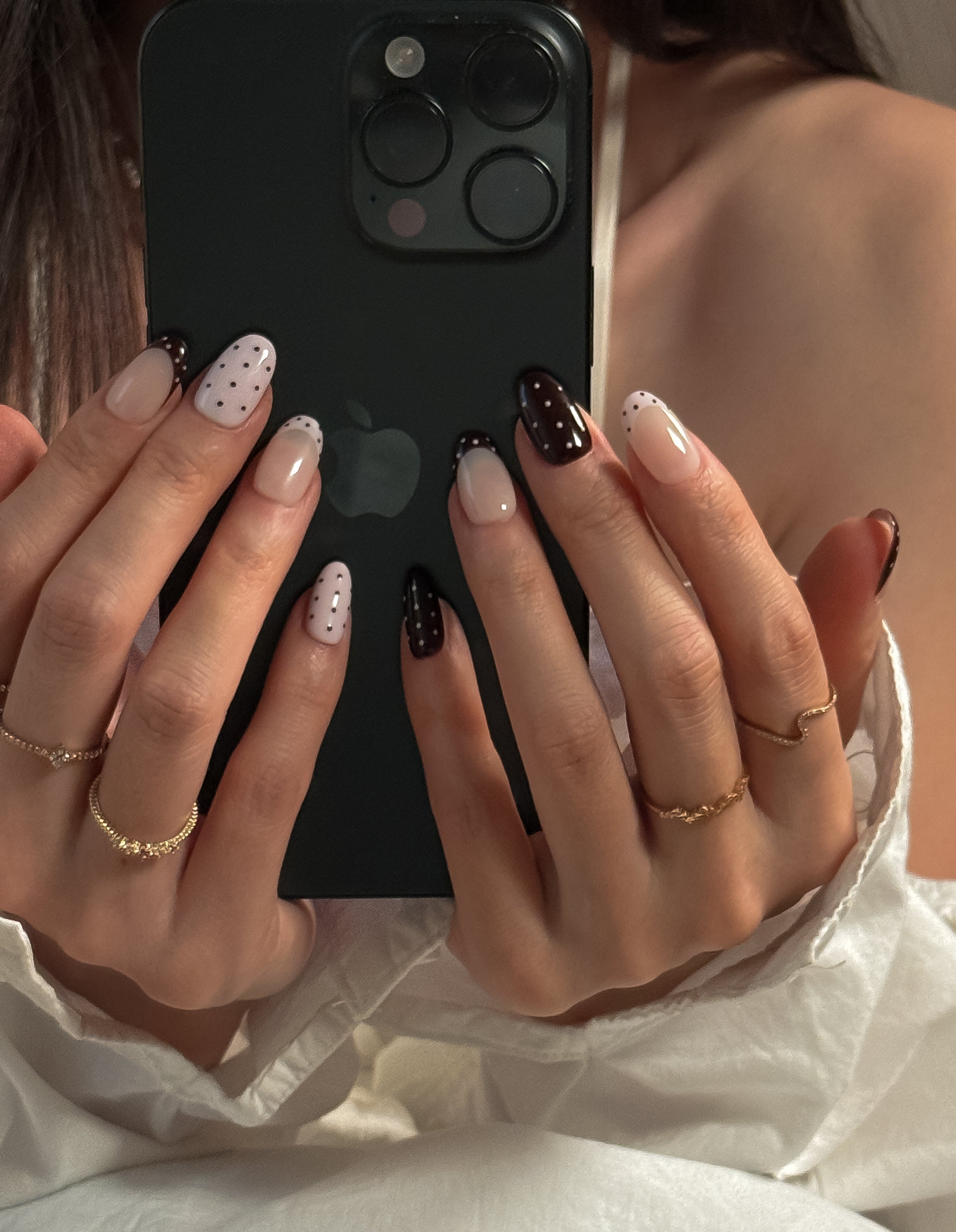 a girl with white dress holding an iphone with mocha dot press on nails, featuring a clean girl image
