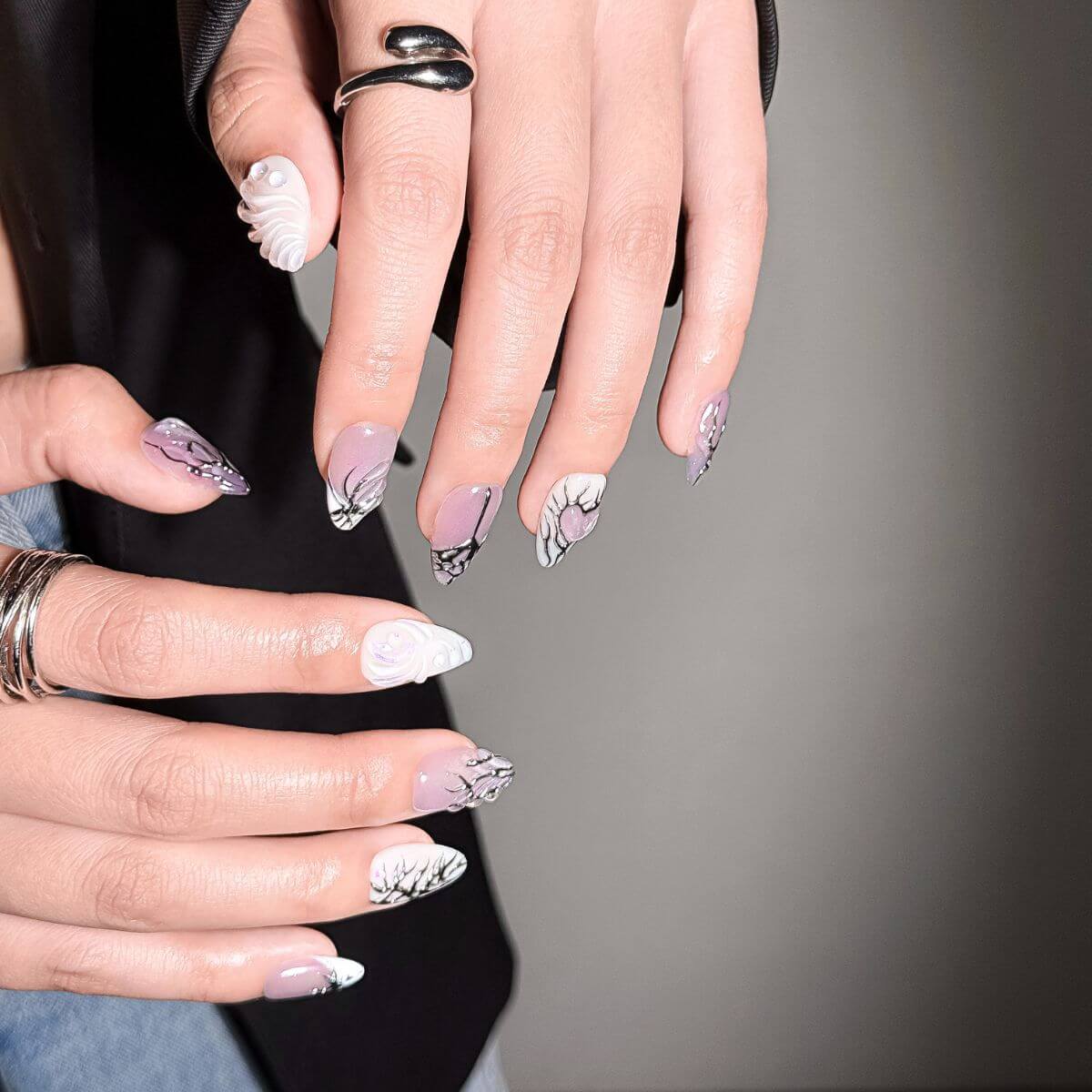 Close-up of justmee press on nails showing the high-gloss lavender cat-eye and 3D textured gel. Perfect for a quick, reusable fake nail application without the salon wait time.