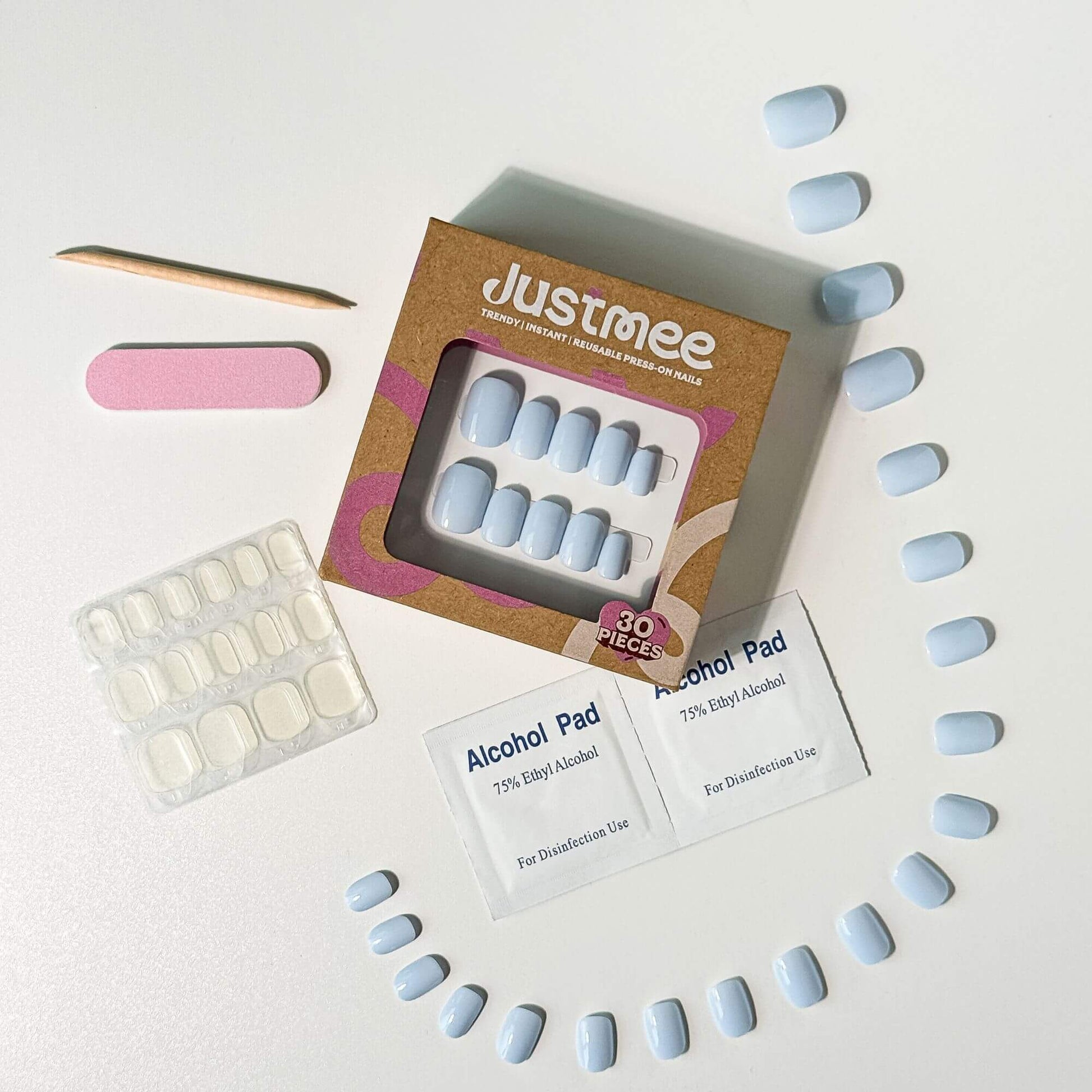 Justmee Blue Mist press-on nail kit: 30 pieces of short pastel baby blue artificial nails with application tools.