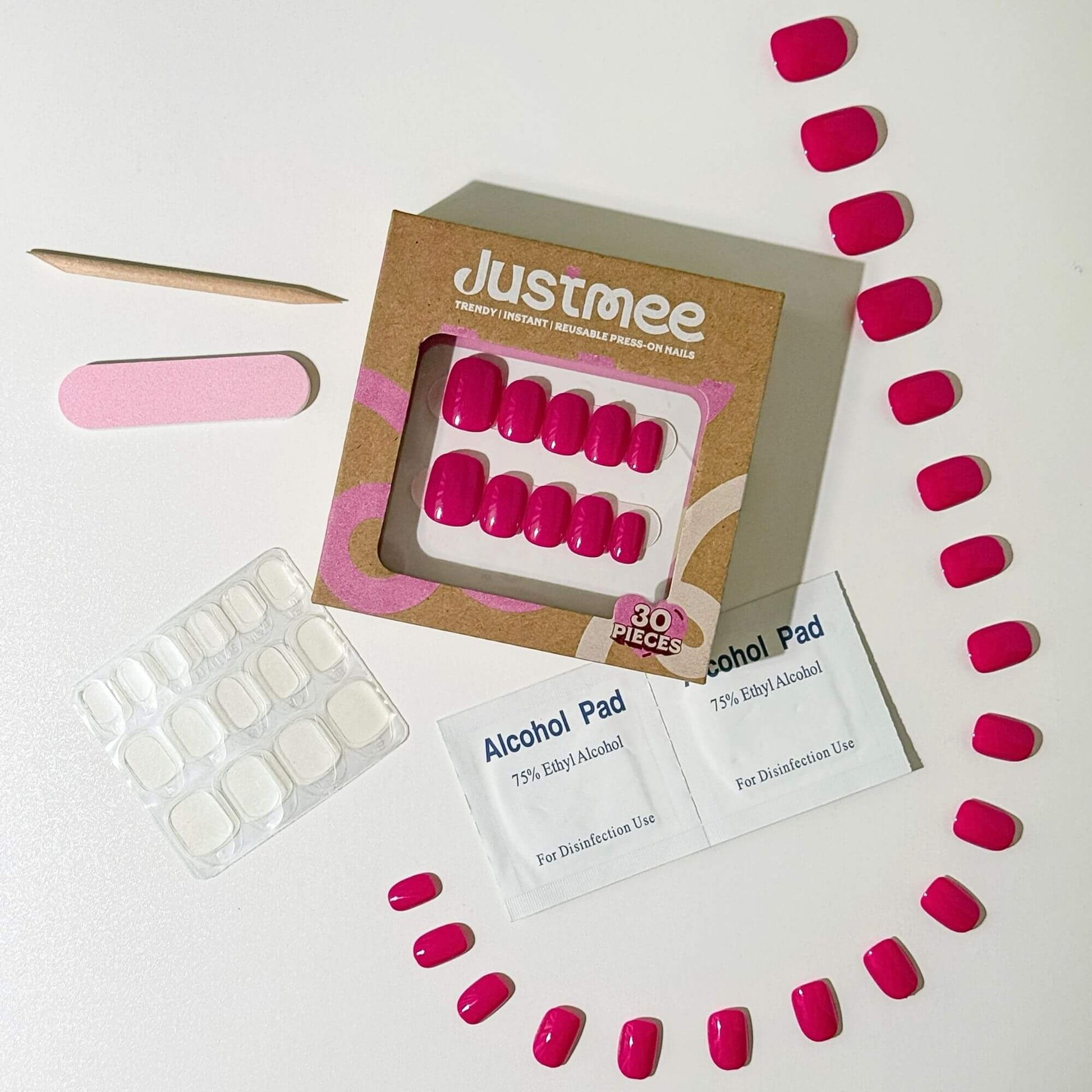 Complete Justmee DIY manicure kit with 30 hot pink round nails, adhesive tabs, nail file, and prep pads.