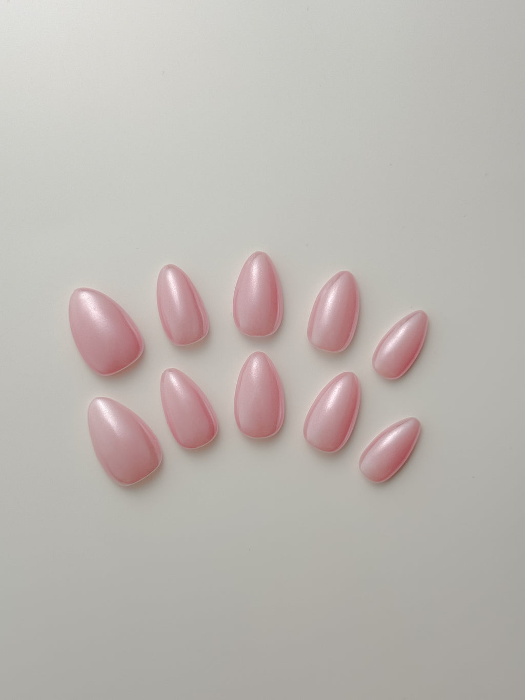 Pink pearl almond press-on nails with glossy shimmer finish, 10-piece set