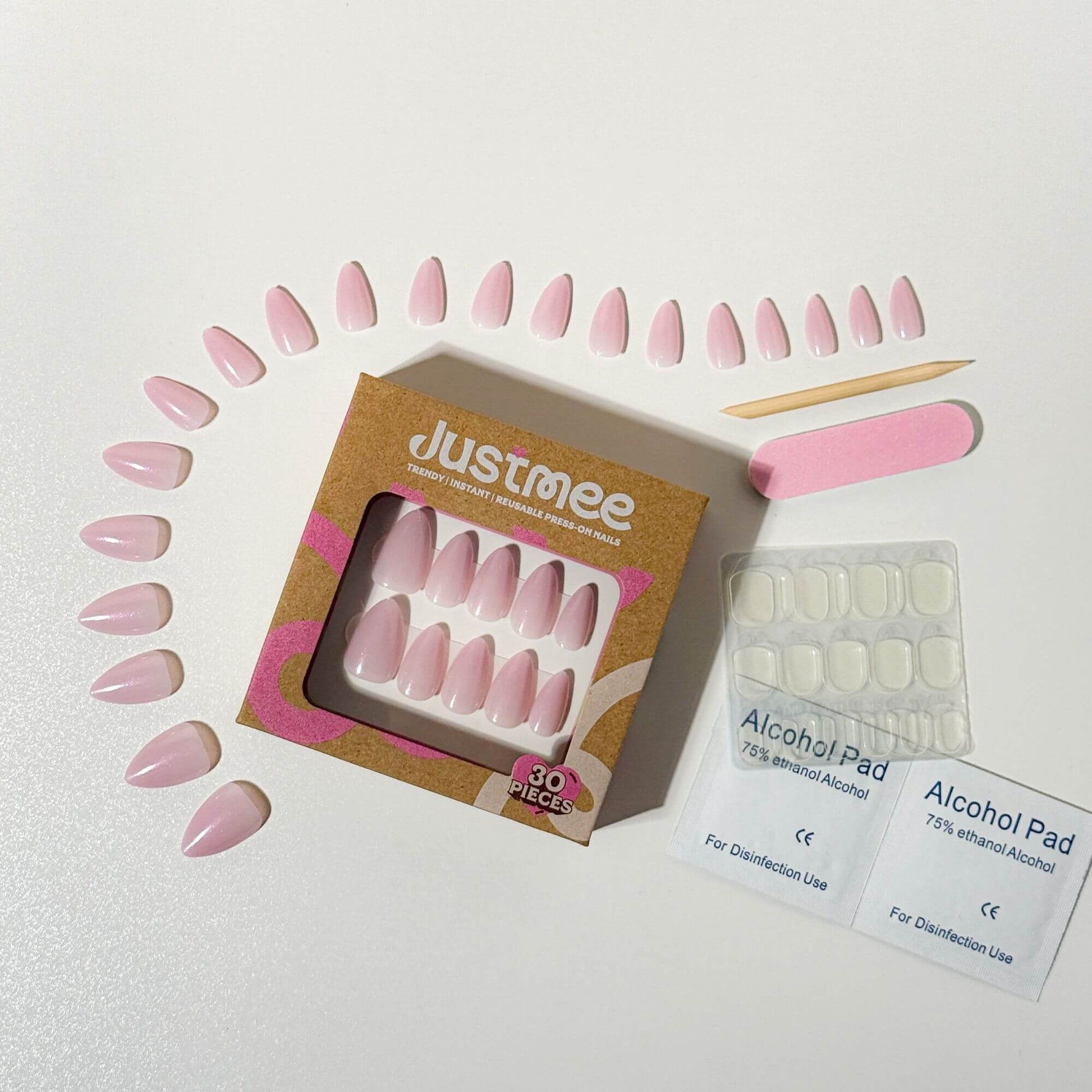 Complete Justmee nail set including 30 silver magnetic almond nails, adhesive tabs, and application tools presented with the pink and kraft paper packaging.